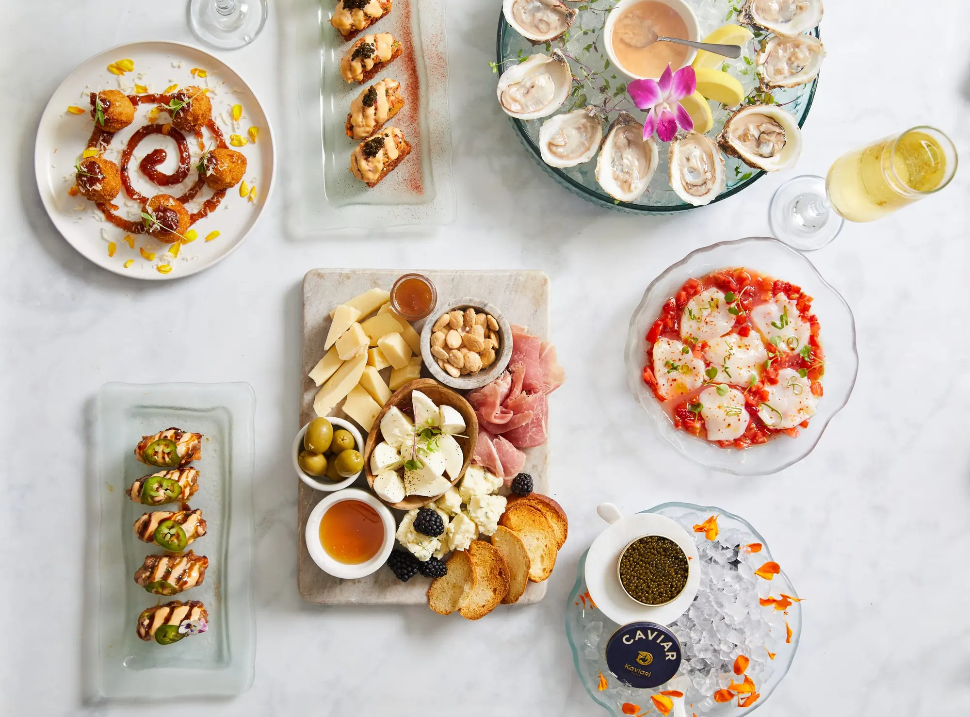 Dishes to share from above: oysters, a cheese and charcuterie board, crudo and caviar