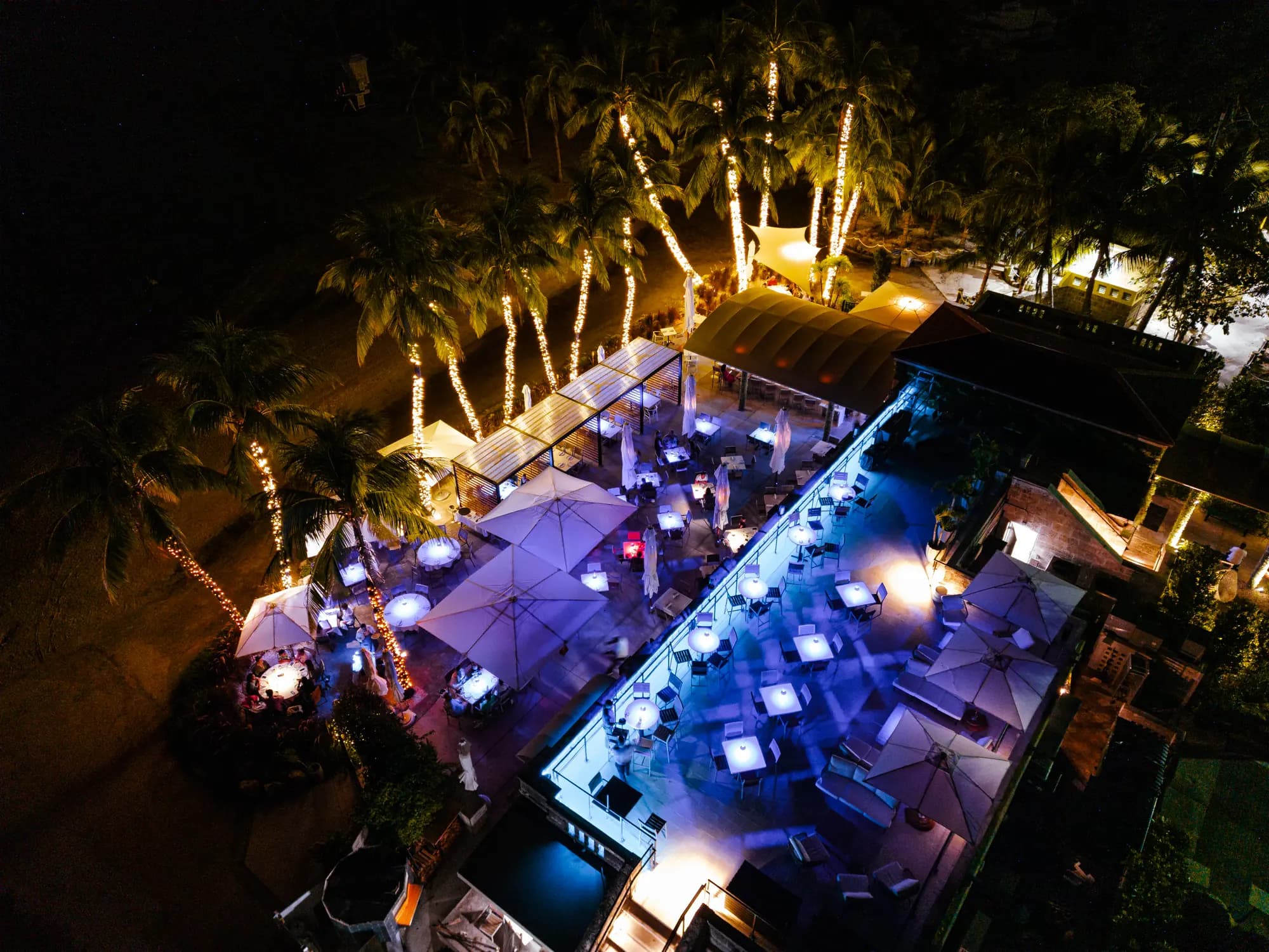 The rooftop lit for a night party, from the air
