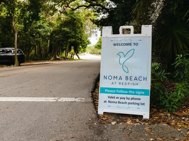 A NOMA BEACH sign beside the park road: please follow the signs