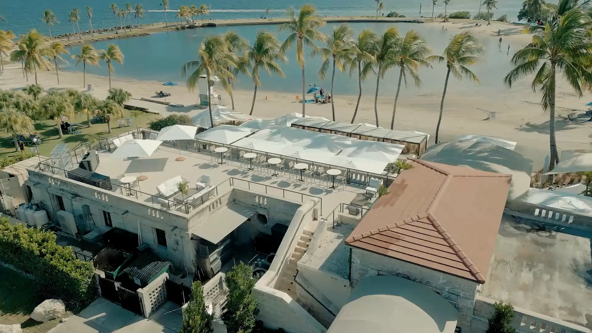 The coral-rock building, its roof terrace and the lagoon, from the air
